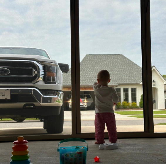 client photo standing by the screen door